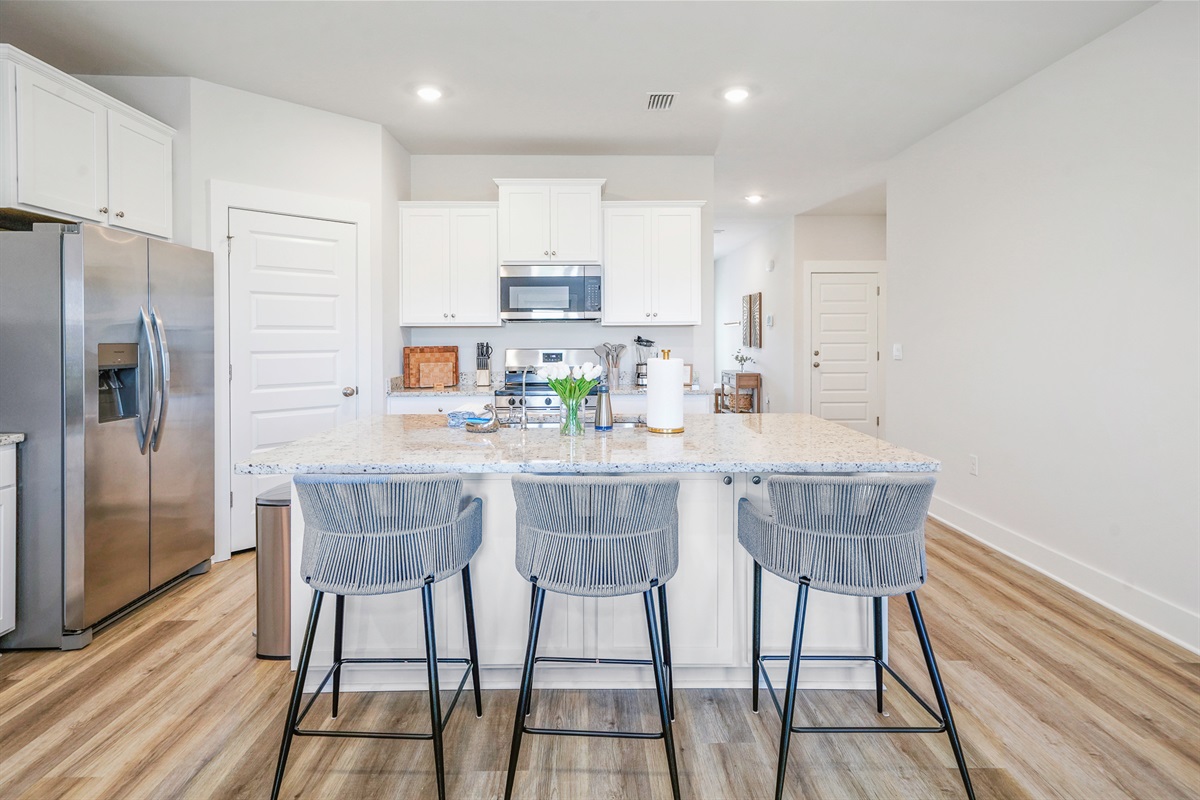 Gather around for meals and memories in this fully stocked kitchen space