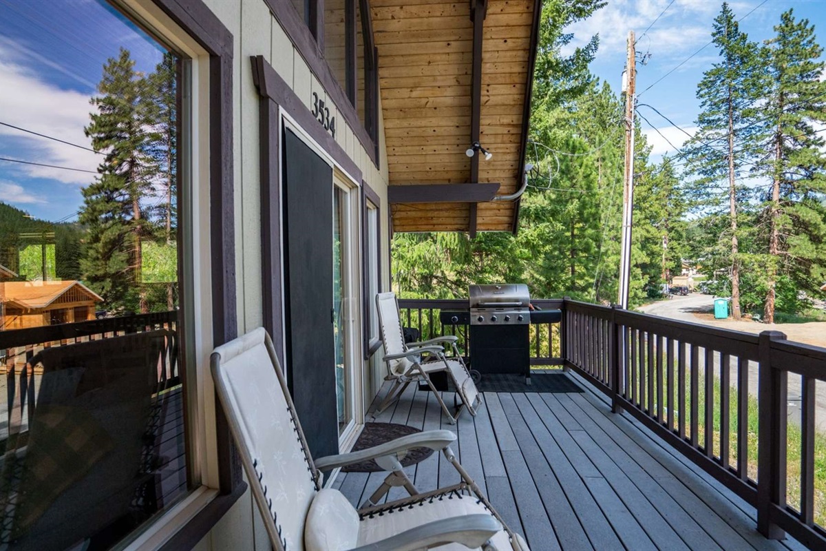 Front deck surrounded by nature — great for lounging or outdoor dining.