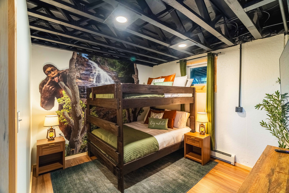 👣 Bigfoot Room 2: a second queen-over-queen bunk (sleeps 4) with waterfall mural and 55" HDTV.