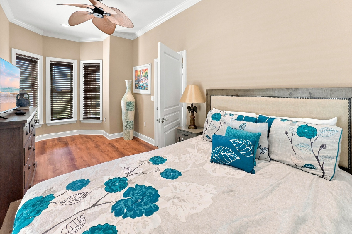 Cheerful bedroom with coastal accents and a ceiling fan