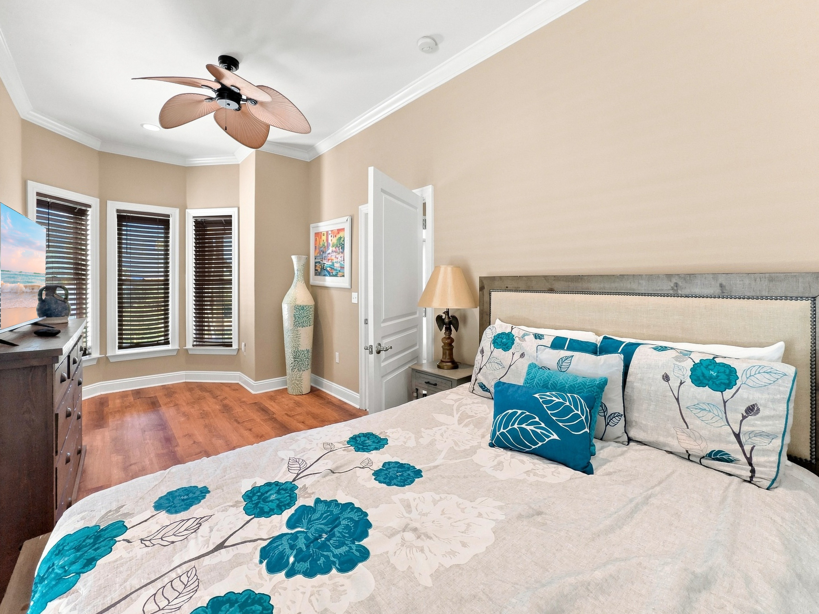 Cheerful bedroom with coastal accents and a ceiling fan