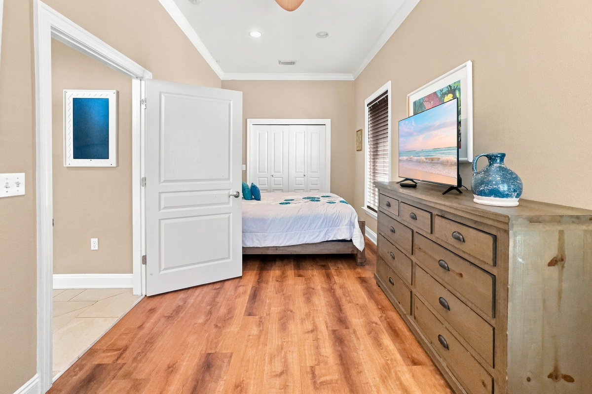 Guest bedroom with a smart TV and dresser storage
