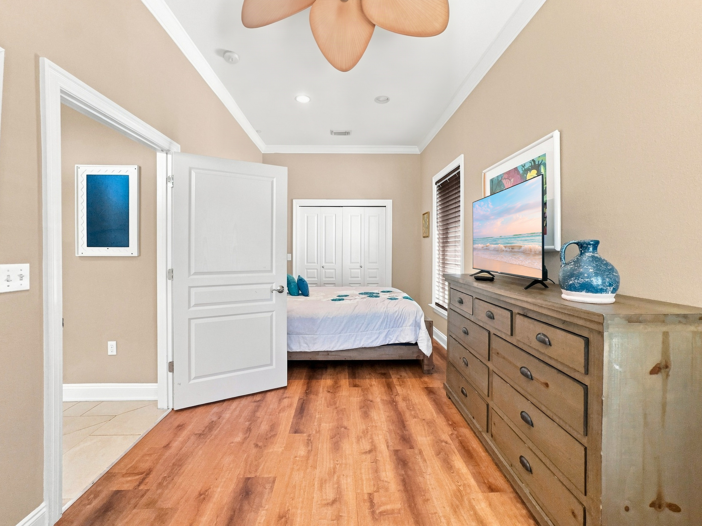 Guest bedroom with a smart TV and dresser storage
