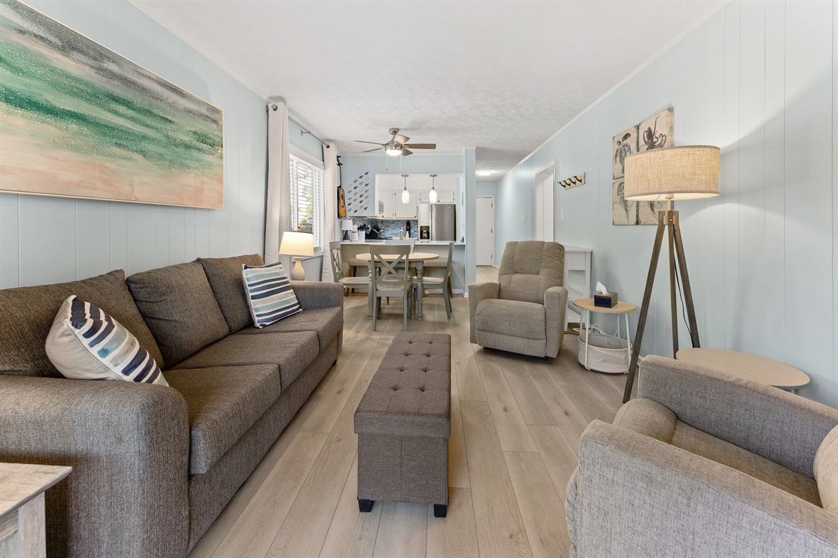 Spacious Living Room area with large TV, sleeper sofa and access to patio.