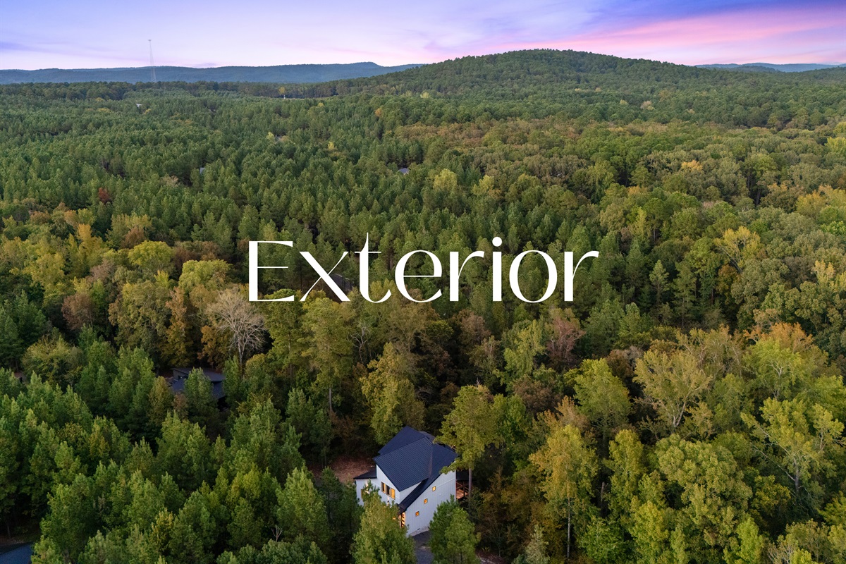 A sweeping aerial view highlights the endless forested landscape that surrounds the property.