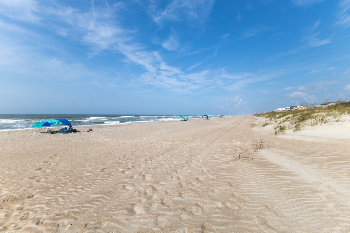 Spend your days relaxing on the wide sandy beach and enjoying the coastal scenery