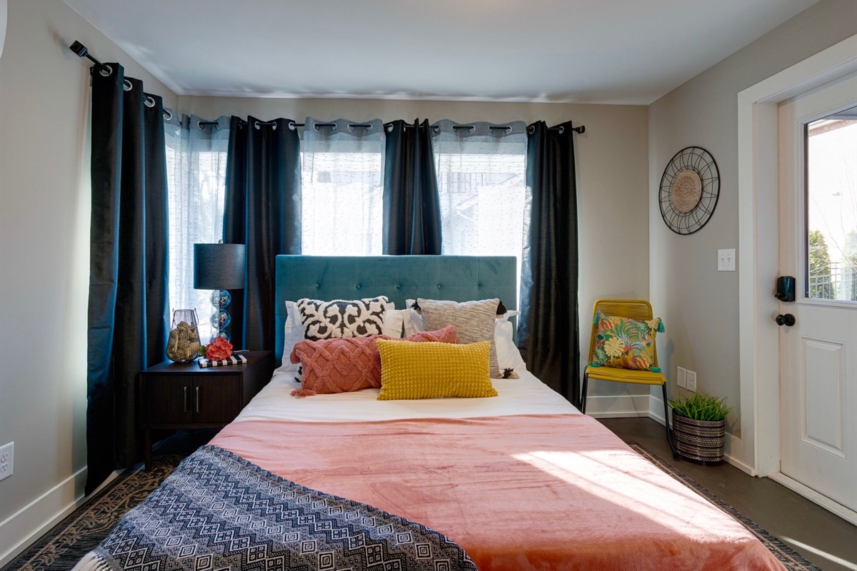 - Bright mornings start here, this cheerful bedroom mixes bold color with soft light - Plush pillows, blackout curtains, and a cozy vibe for the perfect night's rest - Splash of personality in every detail, from the teal headboard to the floral chair