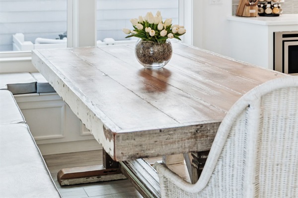Dining area with ample seating in an open-concept layout, adjacent to the kitchen and living area, overlooking the pool.