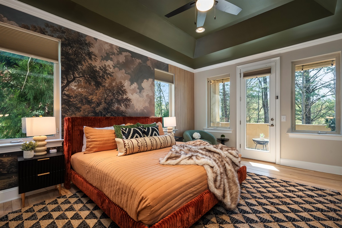 Bedroom with multiple windows and wooded views - brings Asheville’s natural setting indoors