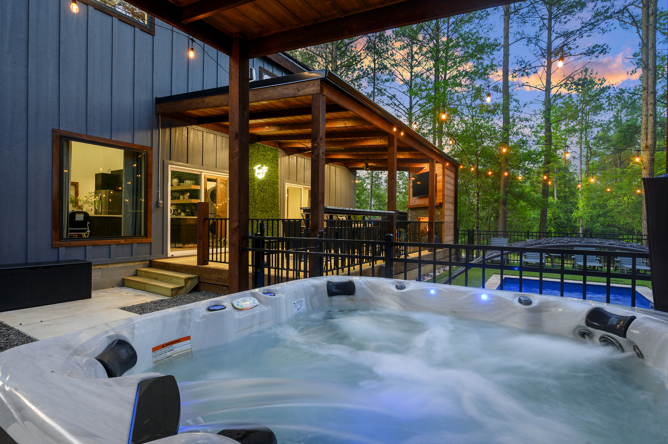 End the day here. Sink into the hot tub beneath the pines as the string lights glow, with the pool, sauna and covered deck just steps away.
