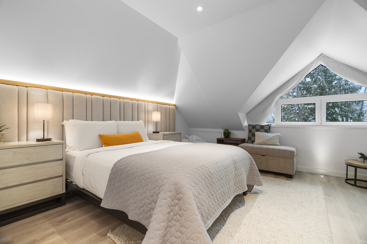 Top-floor primary bedroom with queen bed