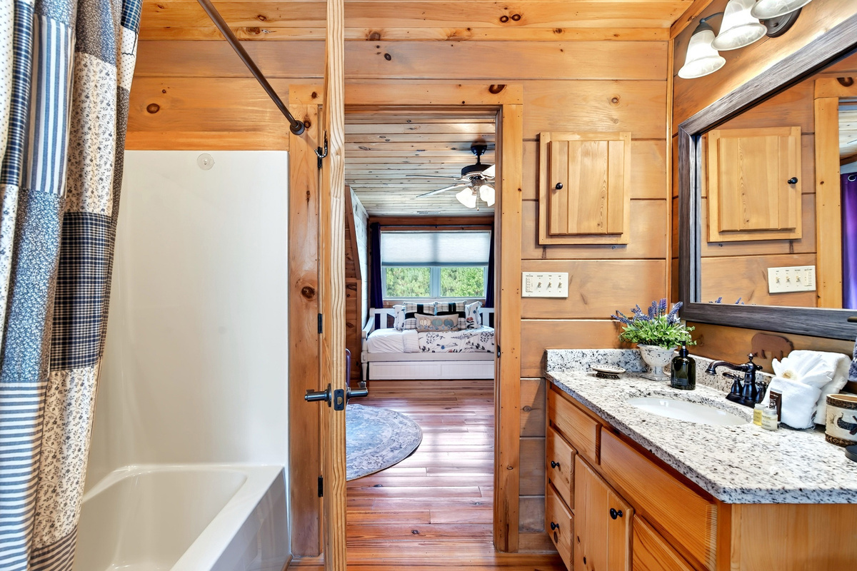 Full bathroom with shower and tub combo in the loft