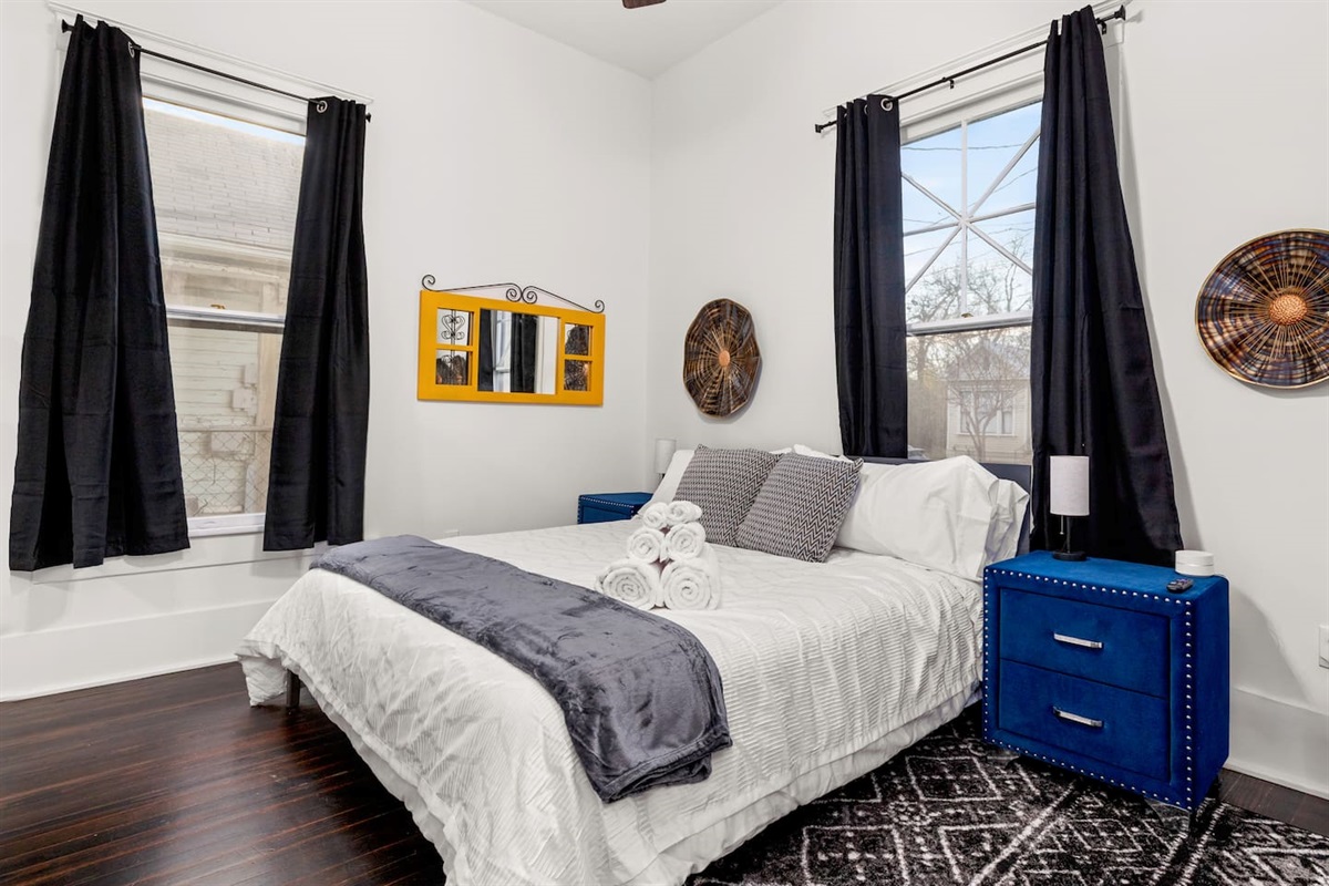 Dream away in our plush bedroom at the front of the home, where modern comforts meet vibrant accents to ensure a restful night's sleep.