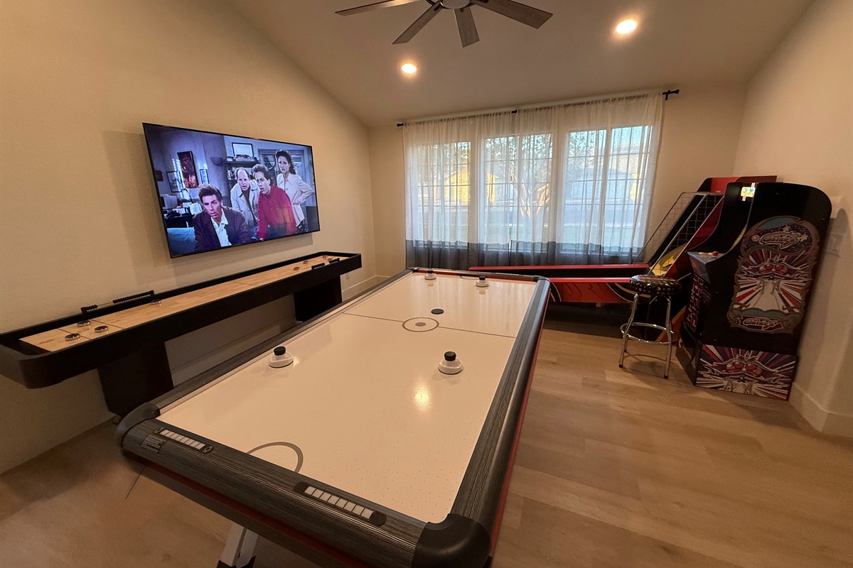 Game room with air hockey, shuffleboard, skee ball, and Ms PacMan