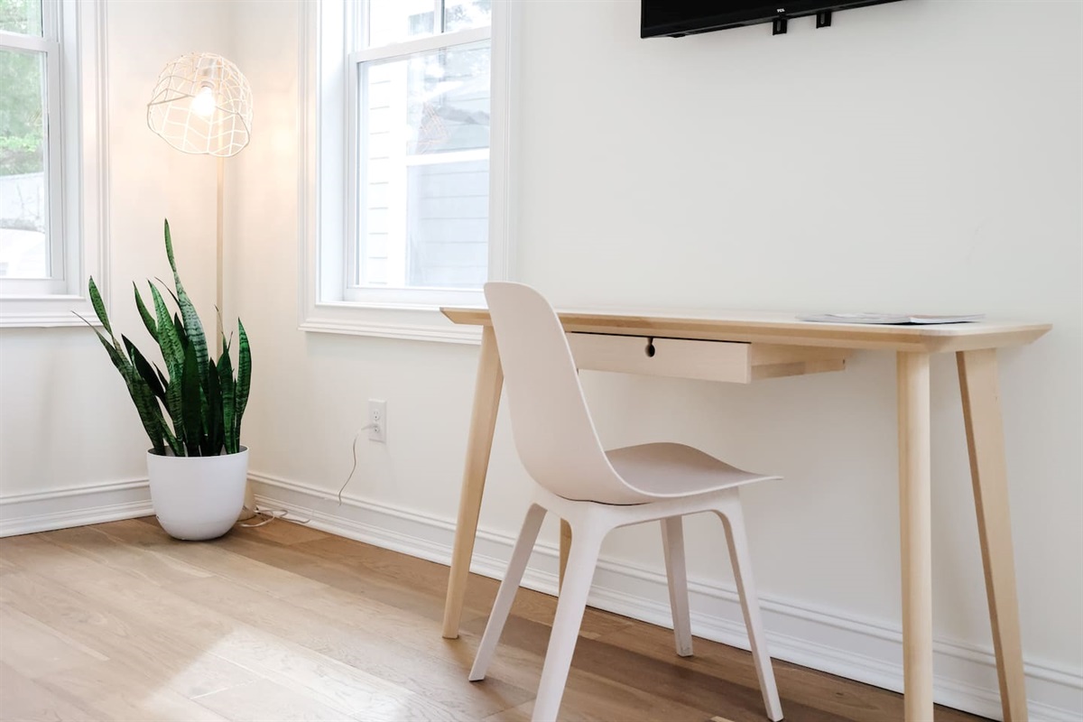 The "rose room" features a queen bed, accents from CB2, a desk for work-from-home, smart TV, a spacious double-door closet and a full bath with a shower tub.