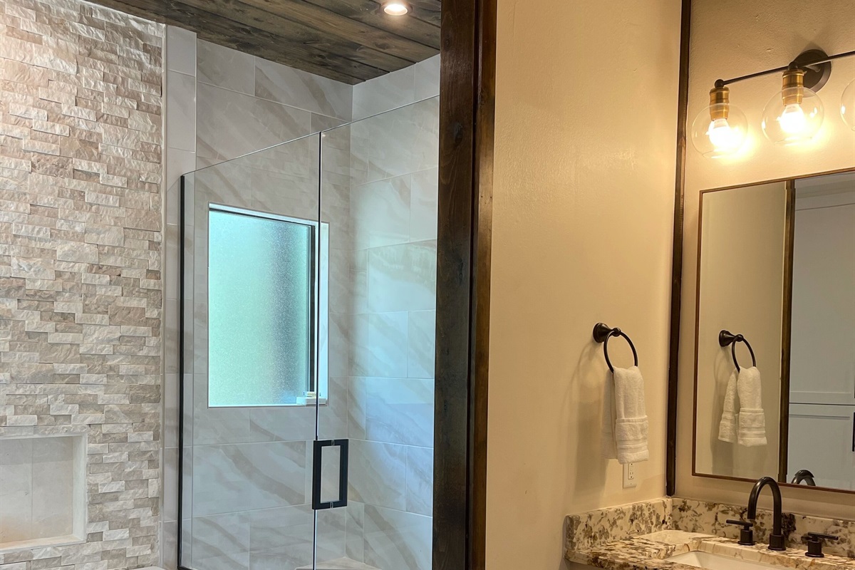 Beautiful stand up shower with river rock floor.