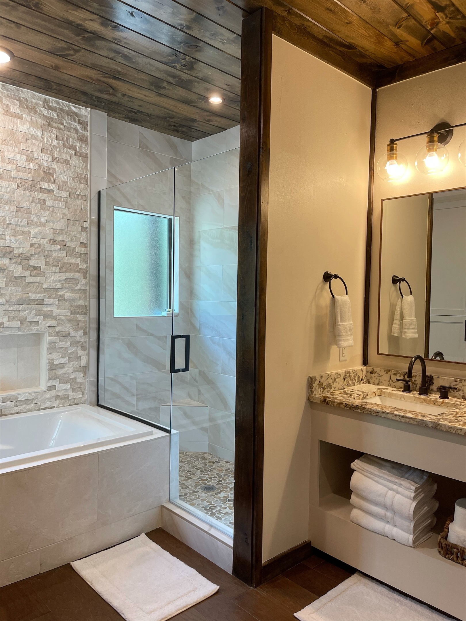 Beautiful stand up shower with river rock floor.