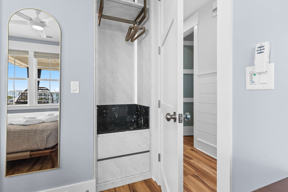 Built-in wardrobes provide ample clothing and luggage storage with two drawers, a hanging bar, and two shelves.
