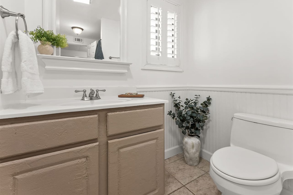 The downstairs bathroom features a shower / tub combo, sink and toilet.