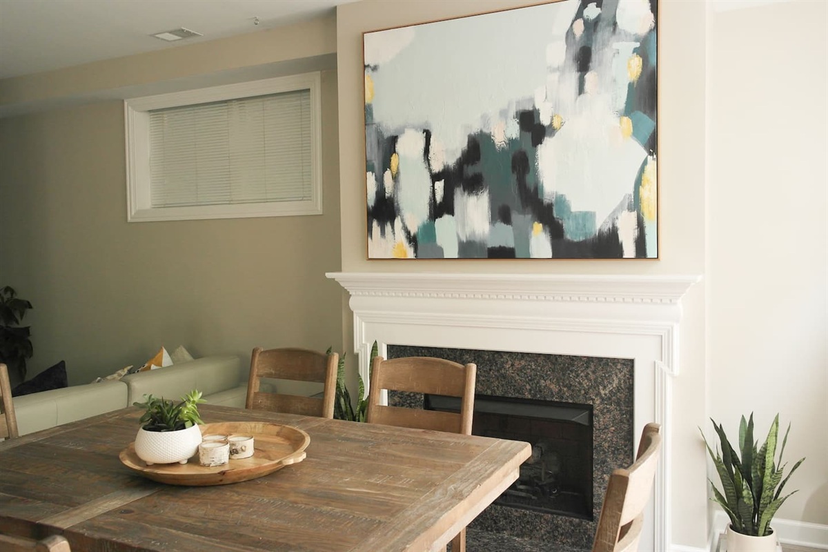 Warm and inviting dinning room with large table — perfect for shared meals, game nights, or planning your Chicago adventures.
