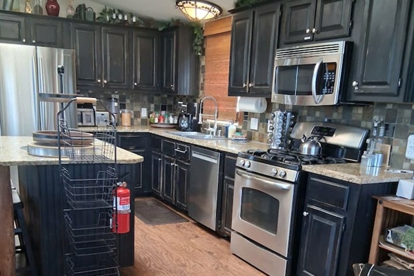 The Kitchen has high-end appliances: browning microwave, dishwasher,  gas stove & more.  It is stocked with cookware for any occasion, and an assortment of spices.