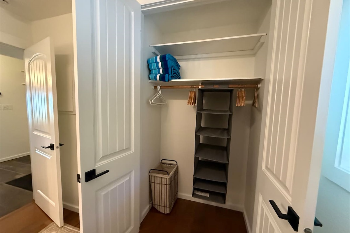 Ample storage in the full size closet with an organizer as a smart storage solution for compact spaces. 