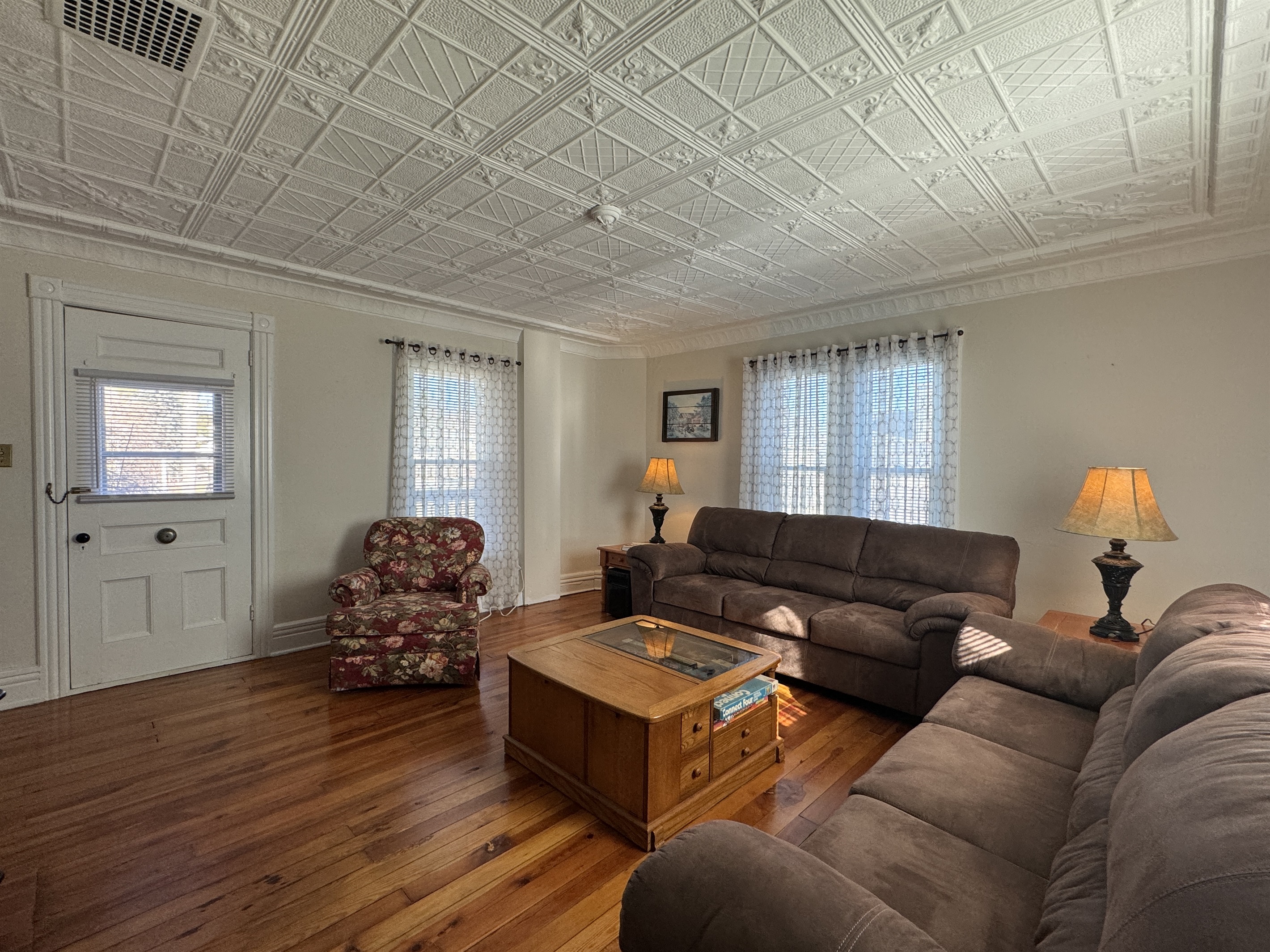 Cooperstown Cottage large living room with access leading to the side porch seating area.