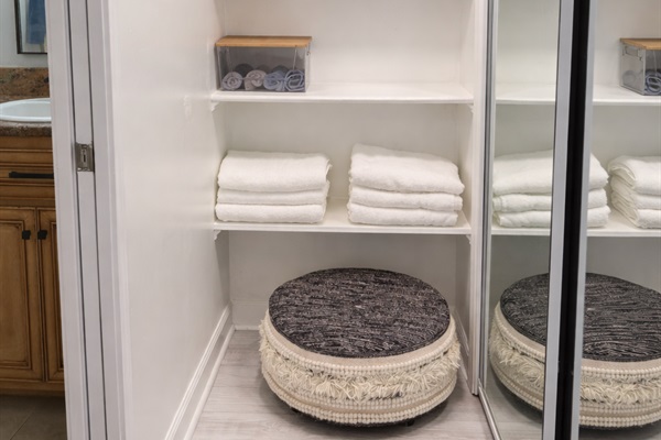 Thoughtfully organized linen closet with plush towels