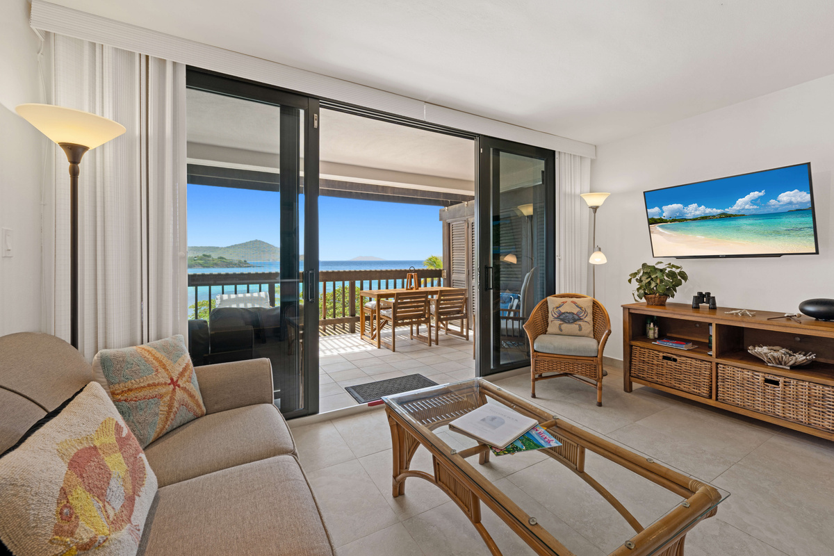 Relax and unwind in the comfortable living space with breathtaking ocean views just beyond the balcony.