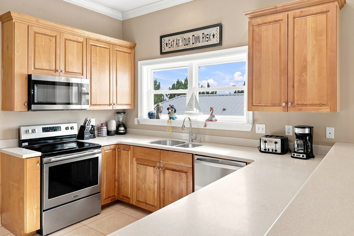 Fully equipped kitchen with stainless steel appliances and generous counter space