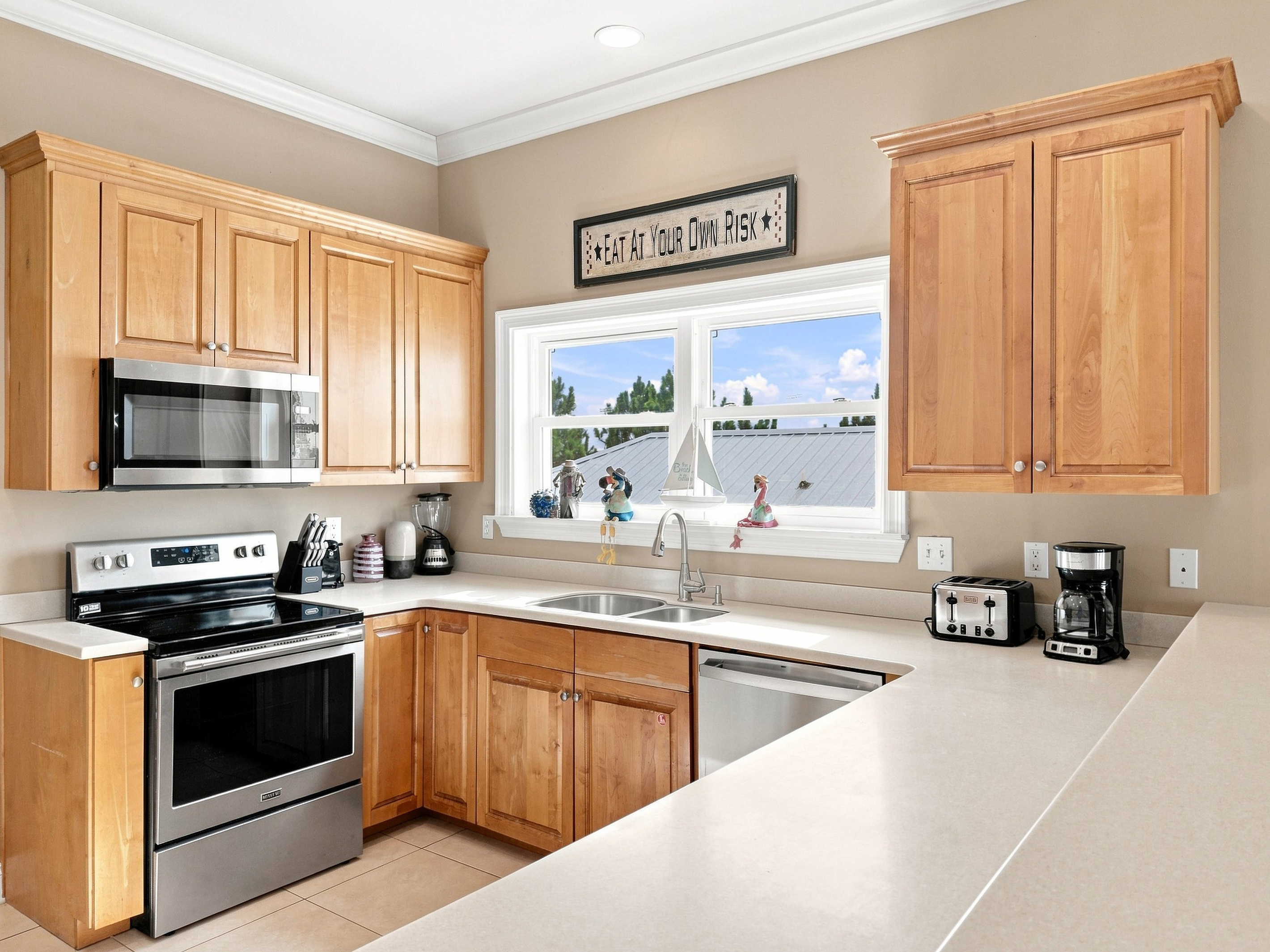 Fully equipped kitchen with stainless steel appliances and generous counter space