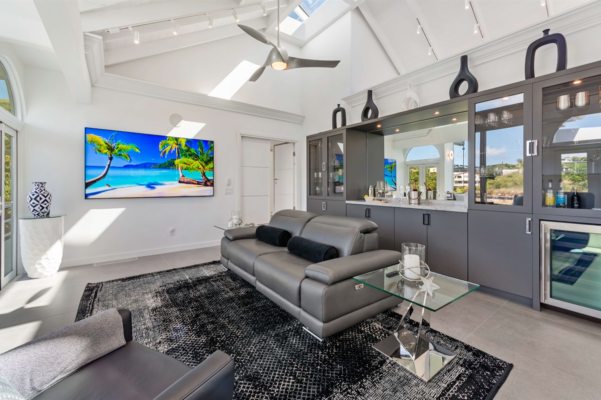 Plenty of seating in the living room with a Smart TV and bar