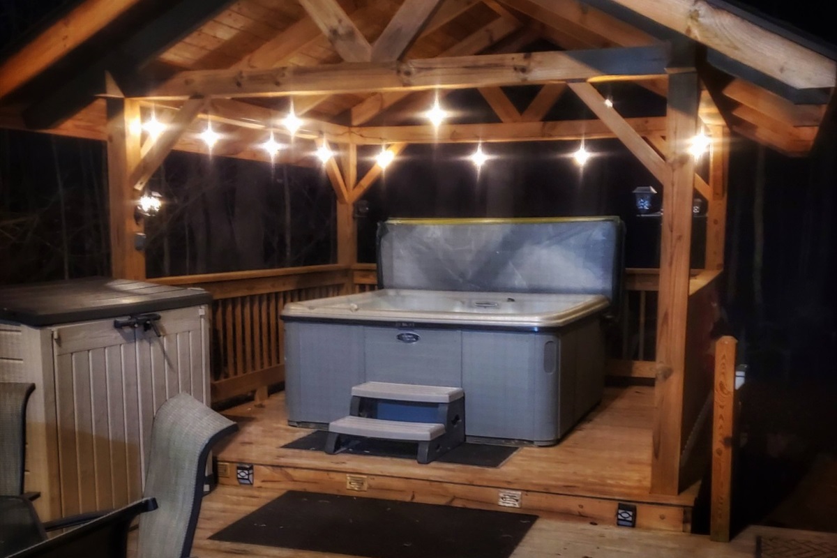 Unwind in the hot tub under the serene glow of the nighttime lights