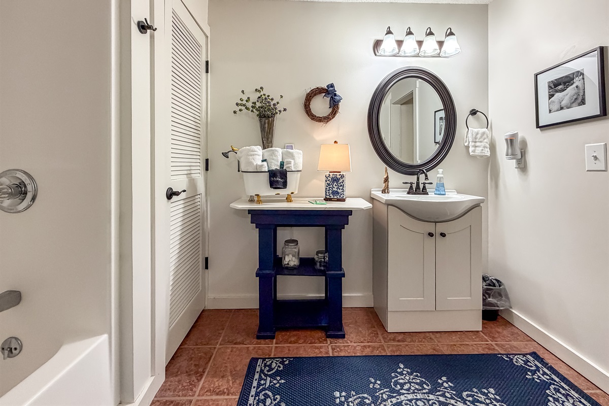 Vanity area and tub/shower combo.