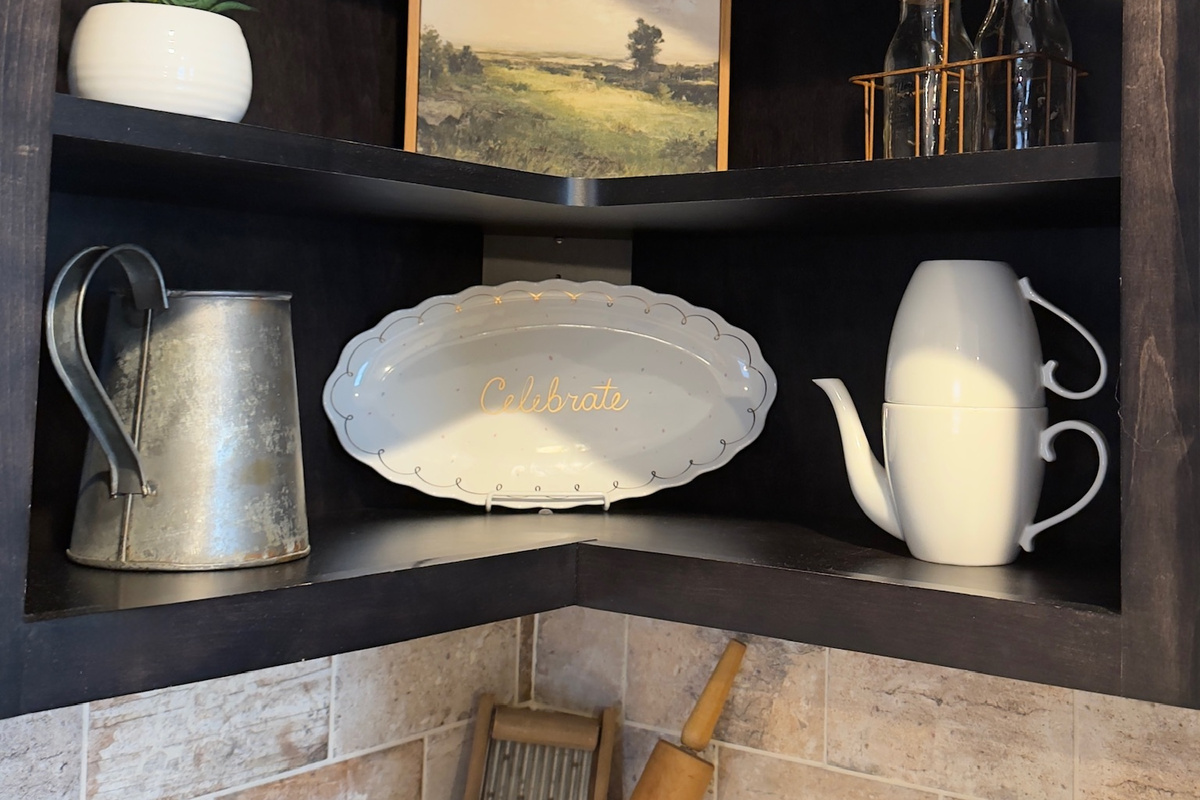 Open kitchen shelving keeps dishes and serving pieces within easy reach.