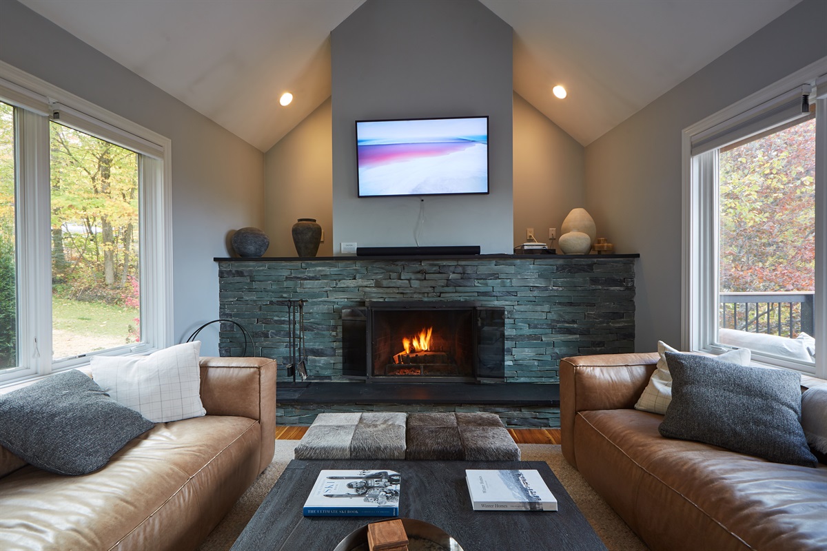 Cozy up by the stunning stone fireplace and unwind in our spacious, modern living room.