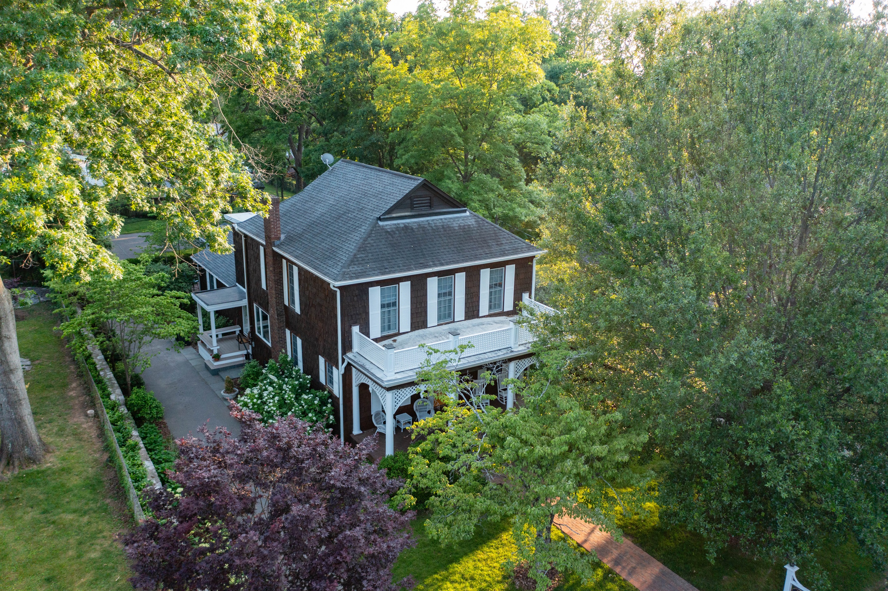 Aerial view highlighting the house's grand design and expansive grounds. 