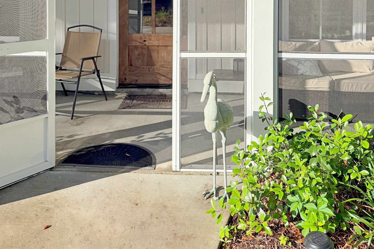 The enclosed porch invites you toward the front entrance.