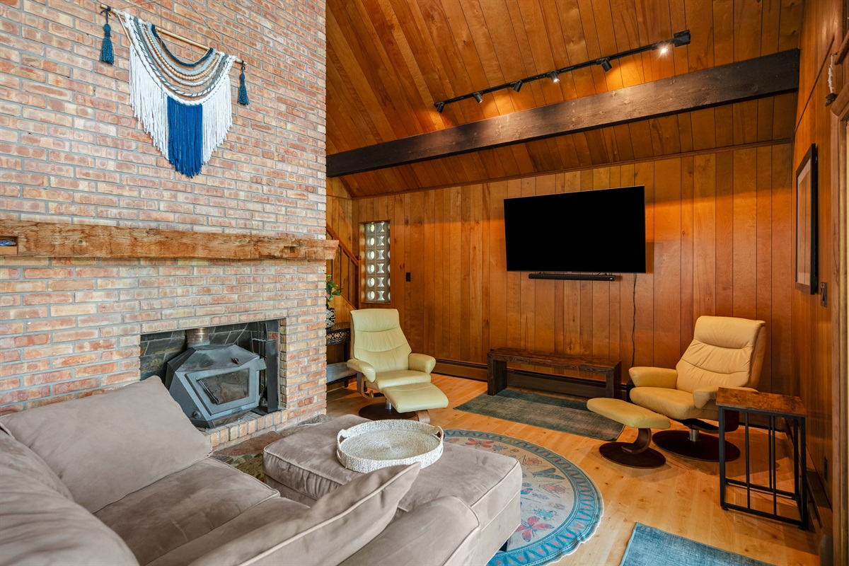 Brick fireplace and cozy seating in the main living room