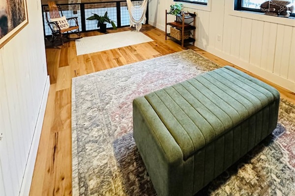 This cozy, open loft features a comfortable queen pullout sofa bed, perfect for two people. The loft overlooks the living room, offering a unique blend of privacy and openness, ideal for those who enjoy a spacious and airy living environment.