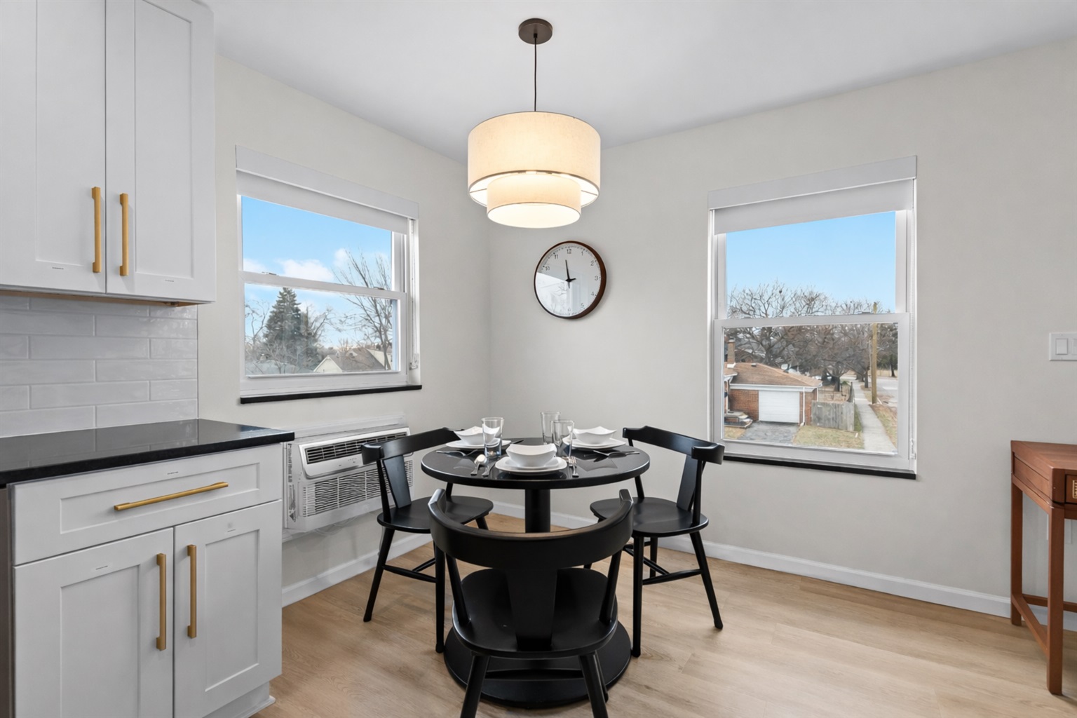 Bright dining nook with modern table seating, natural light, and stylish lighting—perfect for casual meals, coffee breaks, or planning the day ahead.