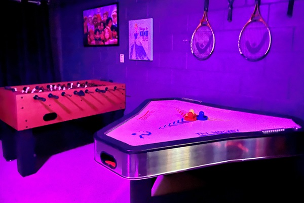 Air hockey and foosball table plus tennis racquets