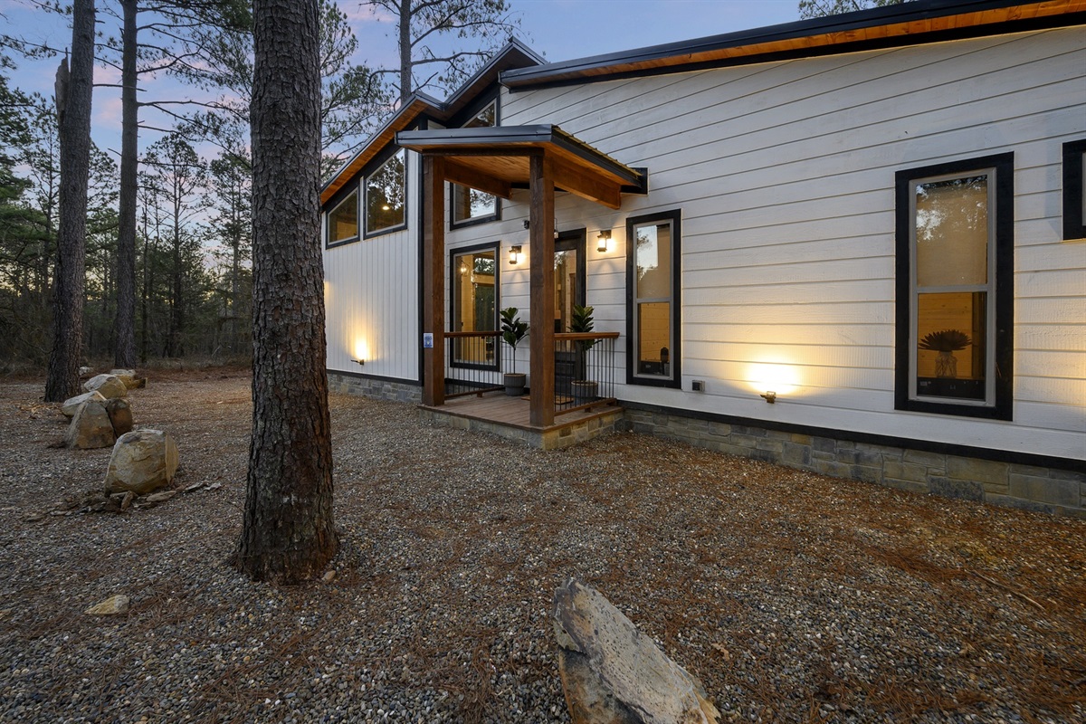 Modern lines meet woodland calm, where warm lights welcome you home after a day of adventure.