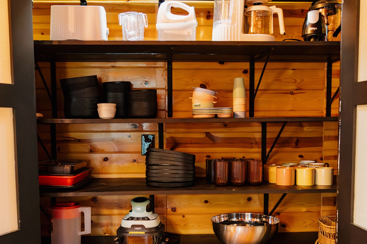 A well-stocked kitchen pantry at Poppywood Pines includes dishes, glassware, and cookware for family meals. This pet-friendly Show Low A-frame provides everything needed for your White Mountains vacation, from coffee makers to serving bowls and bakeware.