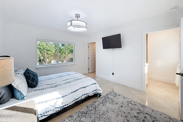 The master bedroom has a view of the side yard, a walk in closet, and a large master en-suite bathroom