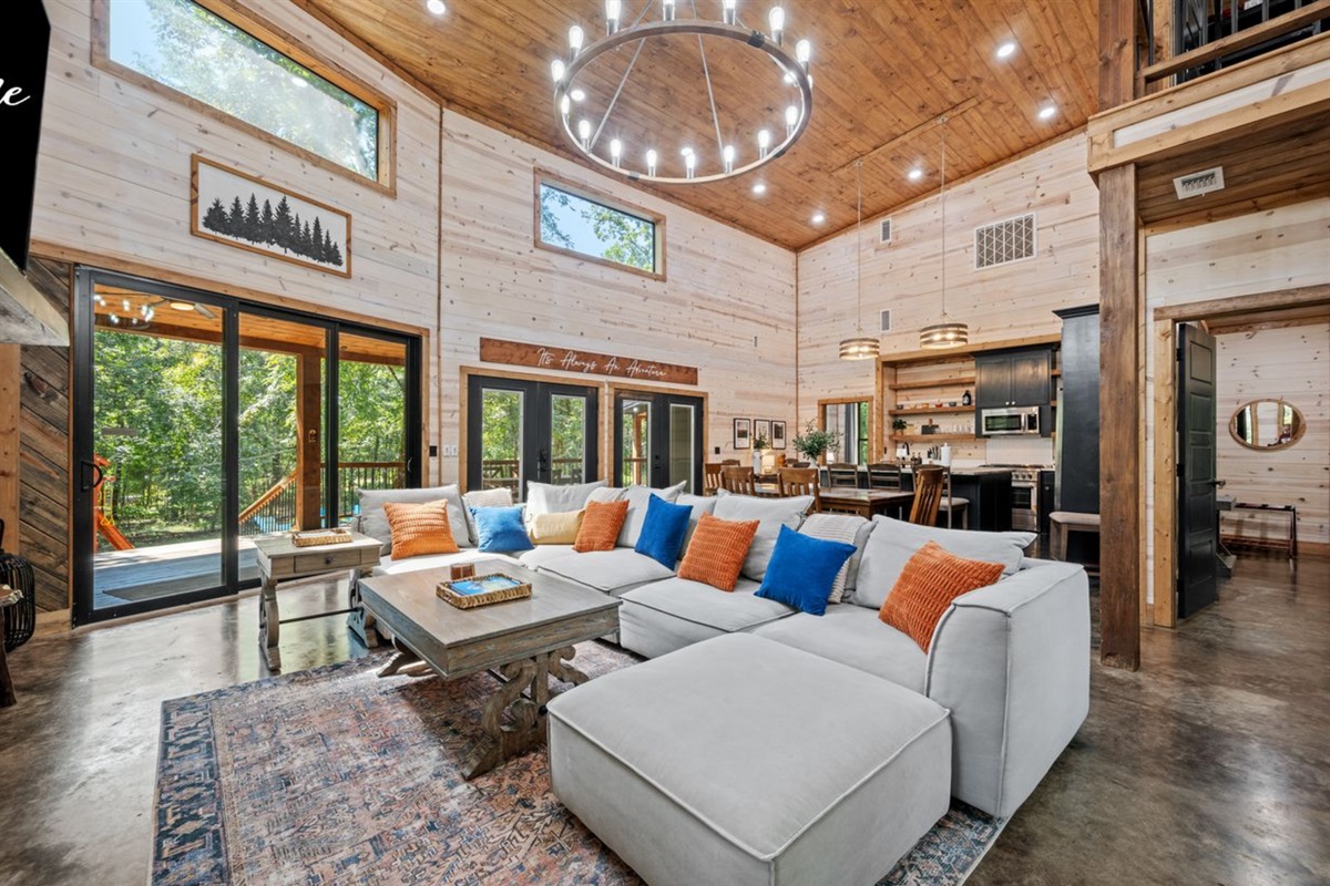 Bright and airy living space with floor to ceiling windows and direct access to the deck.
