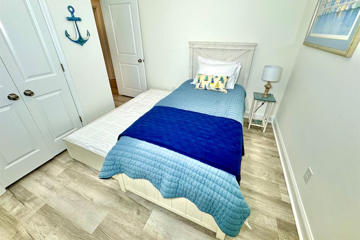 Twin trundle bed with blackout curtains. Linens for bottom twin trundle bed in closet. 