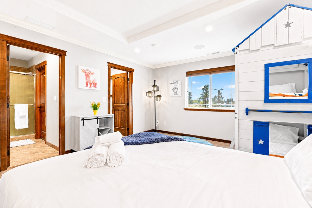 Experience the epitome of family-friendly luxury in our 2ndfloor bedroom. Enjoy the spacious comfort of a queen bed while the kids delight in their playful bunkbeds. With a walk-in closet for added convenience and an ensuite bathroom.