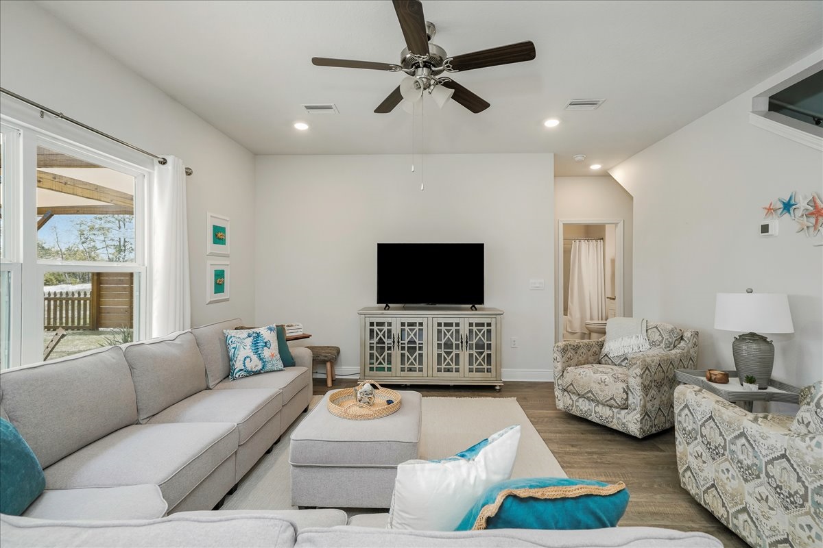 Relax in comfort with cozy seating in the main living room, Smart TV, and a ceiling fan
