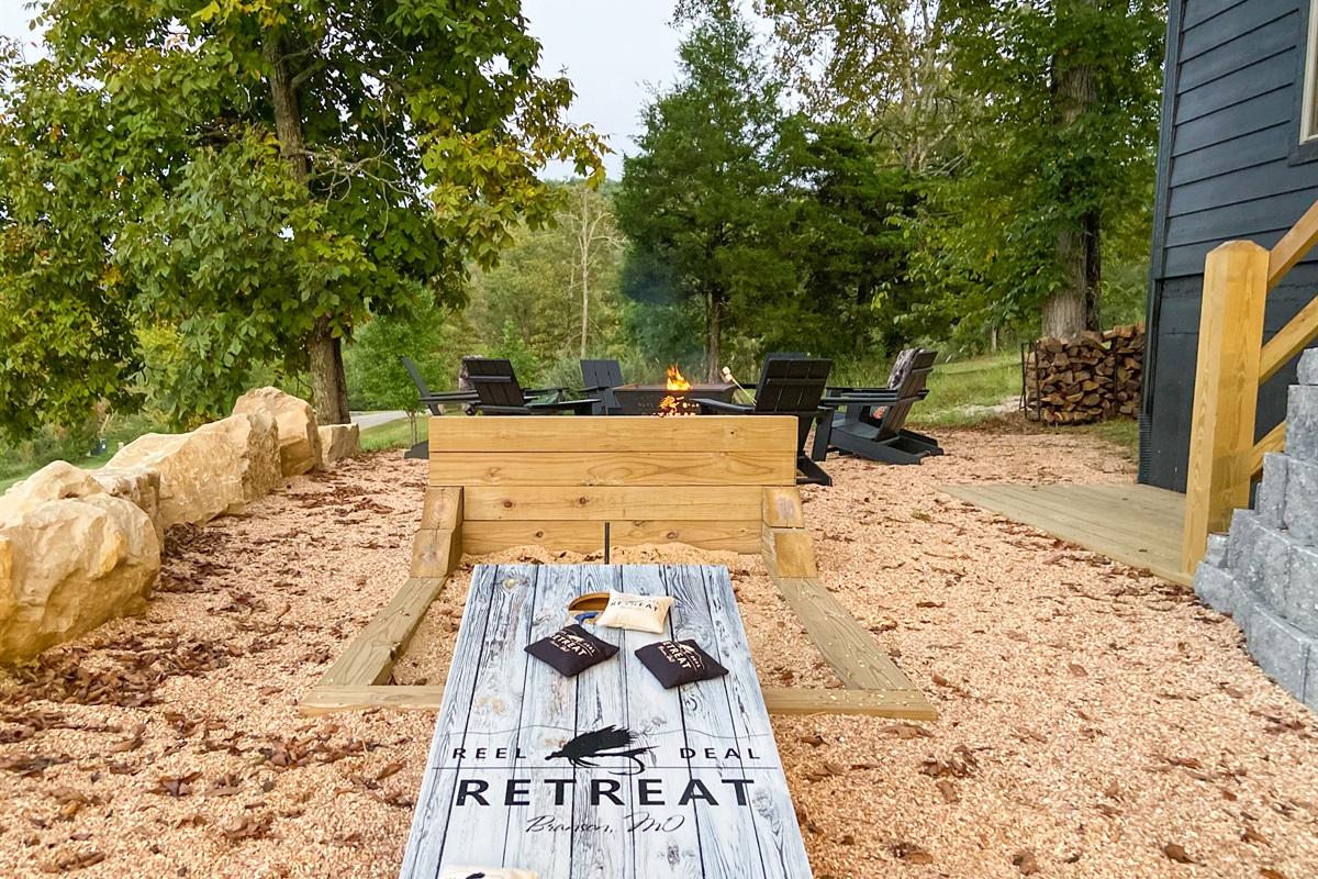 Corn hole, horseshoes, and firepit in the backyard